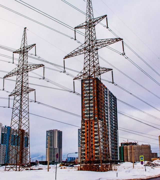 Urban winter scene with high-rise buildings and power lines.